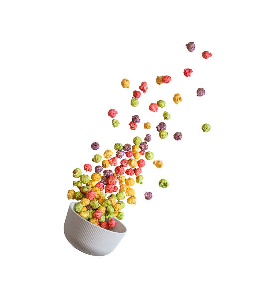 White ceramic bowl from which popcorn flies on white background