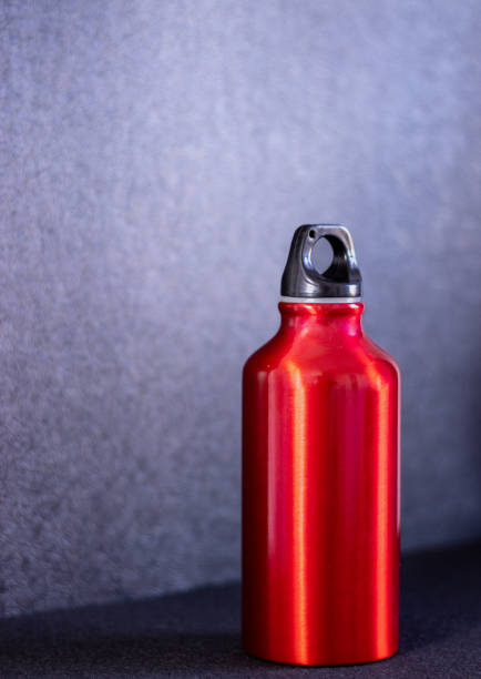 istock Red aluminum bottle on black background 1359331645