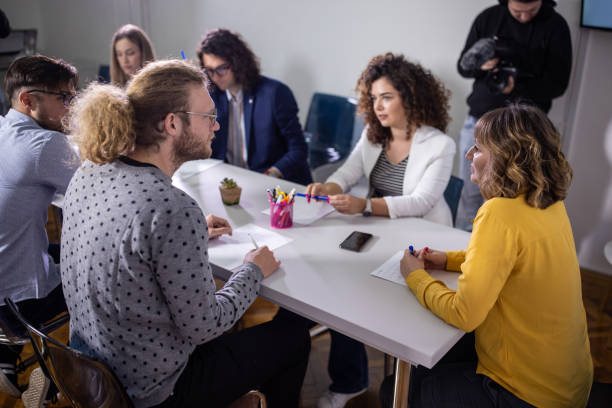 Group of journalist's in the press room During press conference, representatives of various associations answering the journalist's questions interview seminar microphone inside of stock pictures, royalty-free photos & images