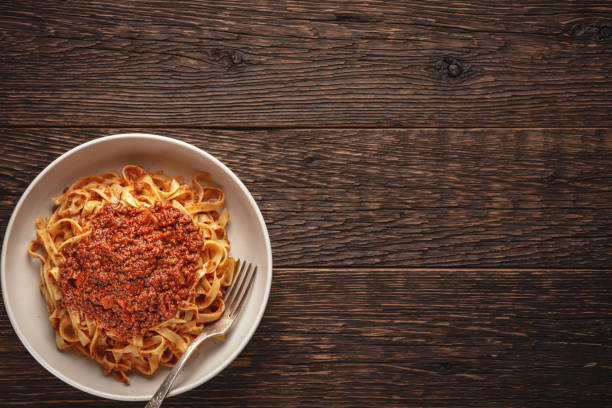 istock Pasta tagliatelle with BOLOGNESE SAUCE on wooden rustic background with copy space 1359333071