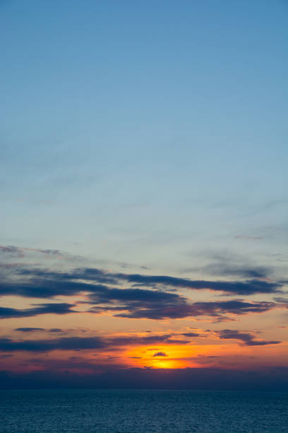 istock Sunset over the calm sea 1359333177