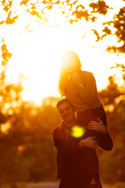 istock Boyfriend holding his girlfriend in his arms before sunset. 1359333202