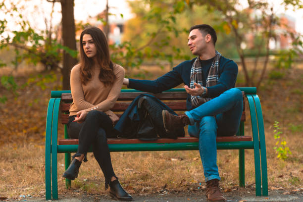 istock Angry girlfriend  ignoring her boyfriend while he is trying to apologize. 1359333280