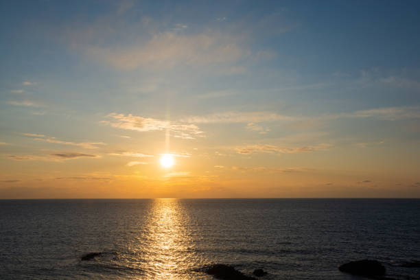 istock Sunset over the calm sea 1359333584