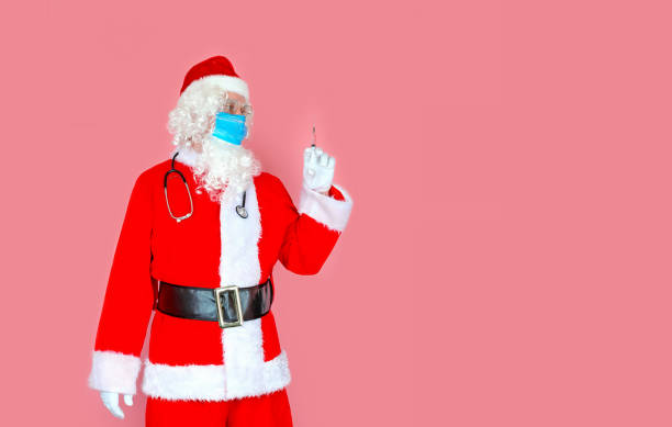 istock Santa Claus is holding a syringe 1359333655