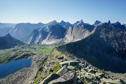 Aerial view of hiker above mountain lake and mountain ranges