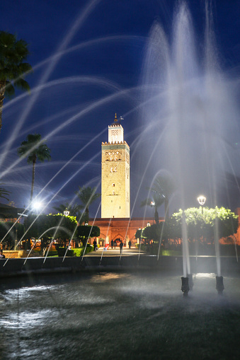 Lalla Hasna park fountain and Koutoubia Mosque in Marrakesh, Morocco.