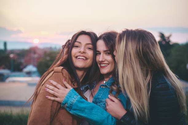 istock Three Young Women Hugging Each Other 1359338395