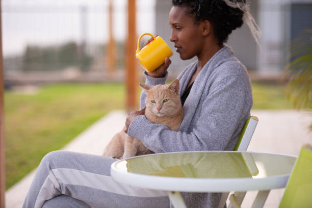 istock Woman petting her cat. 1359339840