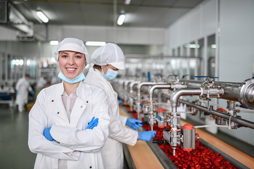 Female Worker Displaying Confidence At Job Position In Factory Making Peppers With Cottage Cheese