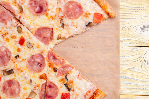 istock Pizza capriciosa without one piece on a baking paper backing. 1359341126