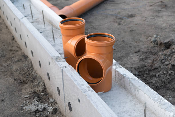 istock Sewer Pipe corner on the construction site. New Orange PVC plastic Drainage pipe Tube 1359342575