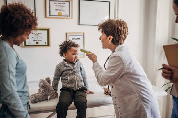 istock Doctor examining little boy 1359344255