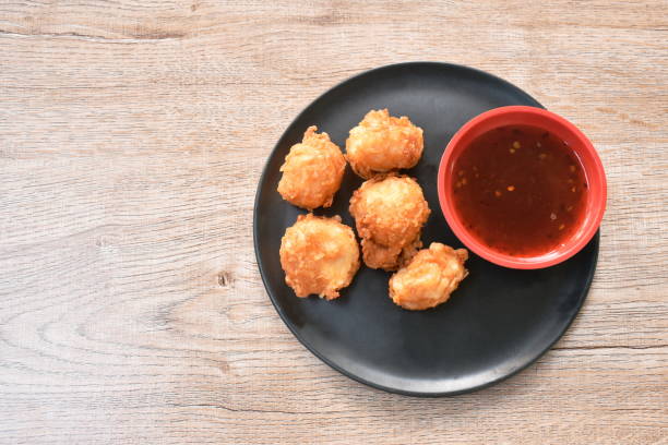 crispy fried squid ball dipping spicy and sweet sauce stock photo