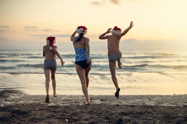 istock Kids running into the sea on Summer Christmas 1359344590
