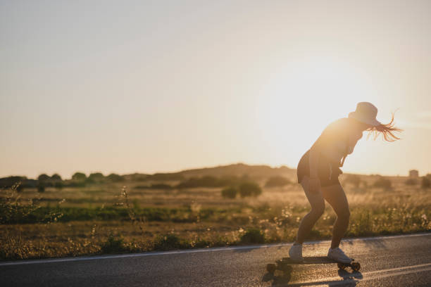 istock Young Caucasian woman on a vacation, riding a longboard 1359344592