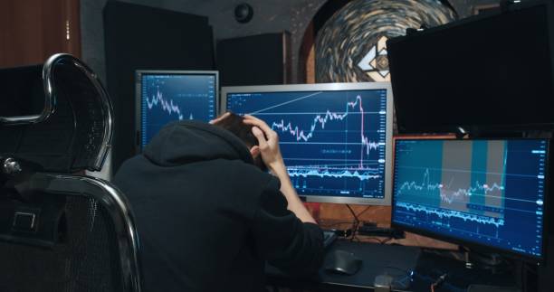 istock Man trader on stock exchange sees drop in quotation chart and gets very upset 1359344732