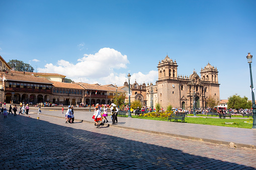 Candid scene showing pedestrians and dance performers in the Plaza Mayor Del Cusco in Cusco, Peru