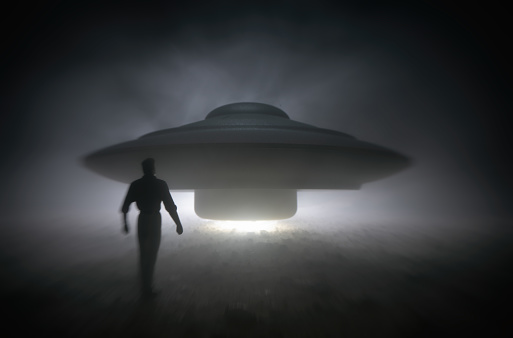 A man approaches an old-style UFO.