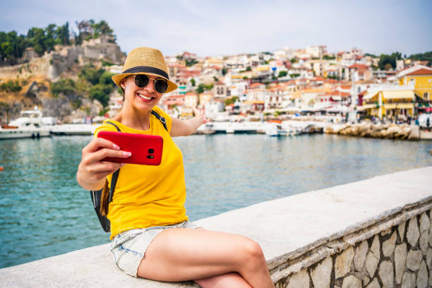 Young woman vlogging from the seaside