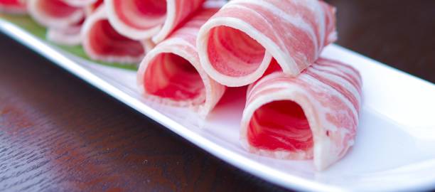 Sliced lamb rolls for hot pot on white plate close up view Sliced lamb rolls for shabu shabu on white plate close up view.
Hot pot or hotpot, also known as soup-food or steamboat, is a cooking method that originated in China, prepared with a simmering pot of soup stock at the dining table, containing a variety of Chinese foodstuffs and ingredients mutton roll for chinese hot pot stock pictures, royalty-free photos & images