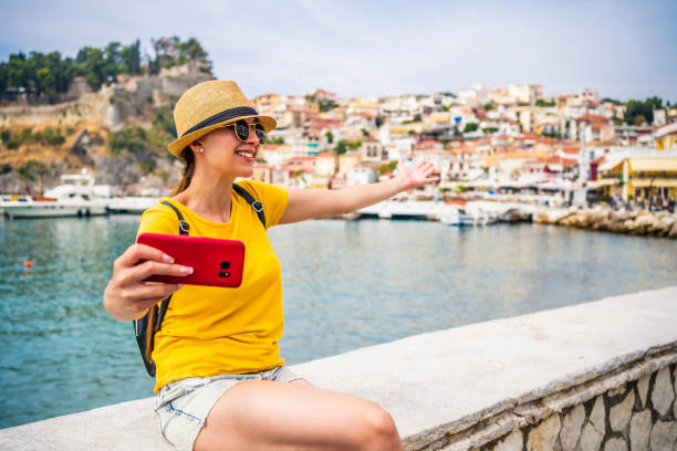 istock Young woman vlogging from the seaside 1359349610