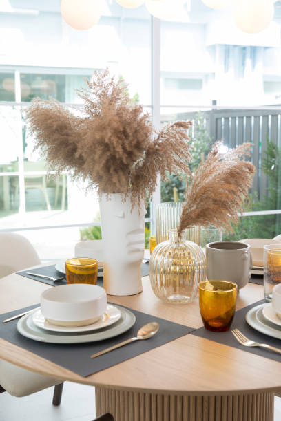 istock Table set on round table in modern style dining room interior of modern home. 1359350781
