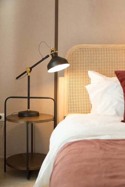 istock Red and brown tone pillow bedding in modern bedroom interior with lamp on table. 1359350782