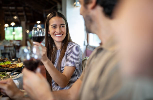 couple having wine during lunch at restaurant - couple restaurant day south america imagens e fotografias de stock