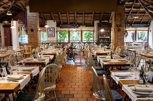 Empty modern restaurant interior with chairs and tables. Interior of a classic-style restaurant.