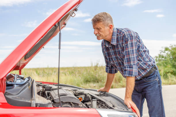 istock Displeased man looking under car hood 1359352044