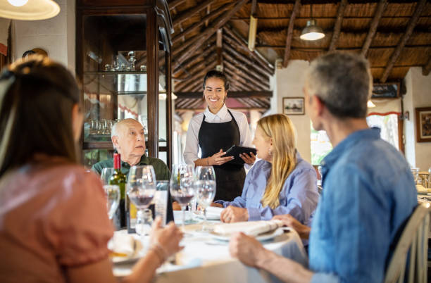 istock Family ordering lunch in restaurant 1359352098
