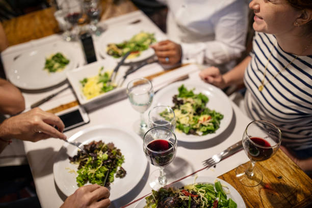 istock Friends having lunch together at restaurant 1359352331