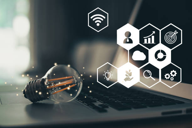 A light bulb placed on the computer laptop with business icon customer network connection on virtual screen. Business innovation technology concept.