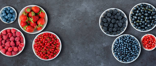 istock Berries in plates on a black concrete background. Copy space. Flat top view. 1359352456
