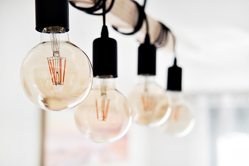 Close up on ceiling in row hanging lot of led vintage bulbs. Interior details concept