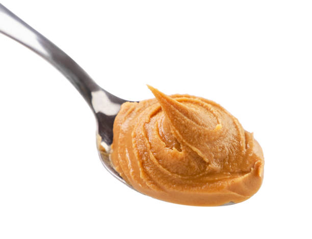 istock Peanut butter in a spoon on a white background. Isolated 1359353831