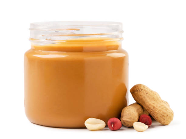 istock Peanut butter in a jar with peanuts on a white background. Isolated 1359353838