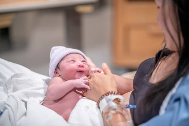 istock New Mother Holding Her Infants Hand 1359354907