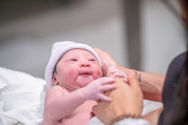 istock New Mother Holding Her Infants Hand 1359354924