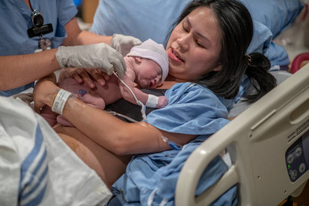 istock Asian Mother Being Presented with Her son After Birth 1359354956