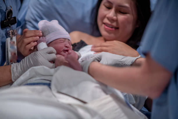 istock Asian Mother Being Presented with Her son After Birth 1359354970