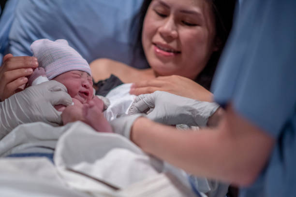 istock Asian Mother Being Presented with Her son After Birth 1359354972