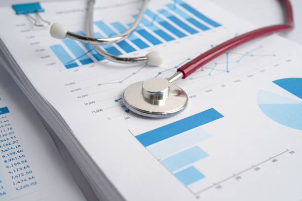 istock Stethoscope on spreadsheet paper, Finance, Account, Statistics, Investment, Analytic research data economy spreadsheet and Business company concept. 1359355461