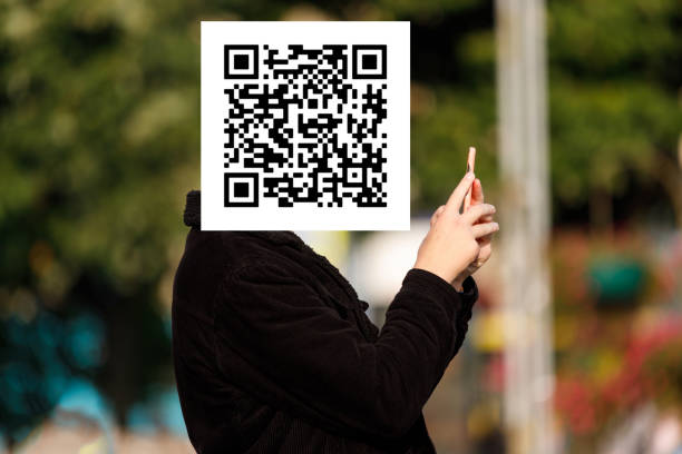 istock qr code on the face of a person holding a phone in his hand 1359355997