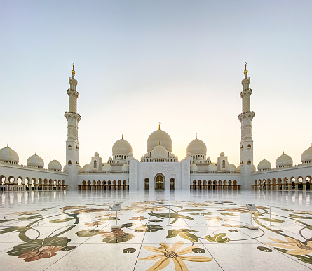 Visitors at the Sheikh Zayed Grand Mosque in the capital city of Abu Dhabi, United Arab Emirates. It is the largest mosque in the UAE