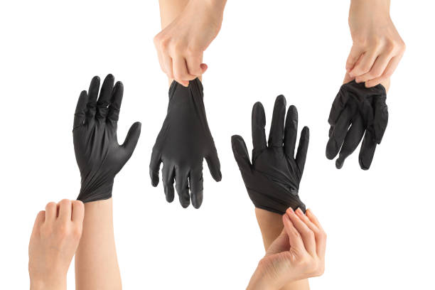 istock Woman puts on black rubber gloves. 1359357945