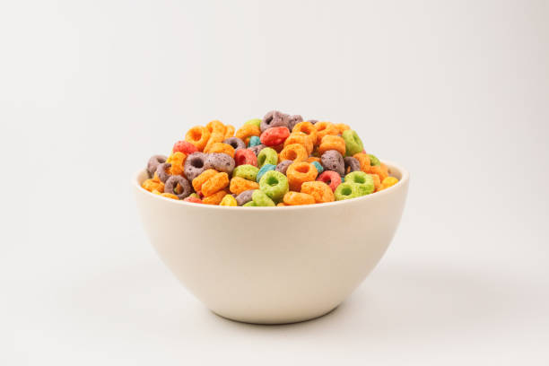 istock Colorful rings cereal spill out into a bowl. Breakfast. Isolated. 1359358074