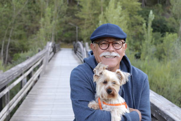 istock Tender senior man and his small dog 1359359408