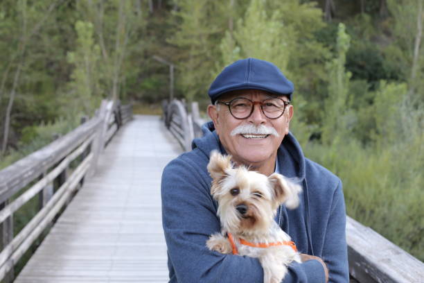 istock Tender senior man and his small dog 1359359817